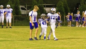 Gabe Griffin, center, with his two brothers, Turner (left) and Cooper (right) beside him before Chelsea White played Chelsea Blue on Sept. 8. The three were team captains for the game. (For the Reporter / Dawn Harrison)