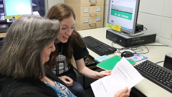 Senior Meredith Revel and her mom Annmarie Revel examine paperwork and websites that may lead to scholarships at the PHS Scholarship Workshop. (Contributed)