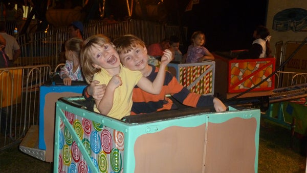 First cousins Bird and Tripp Robinson enjoy the Shelby County Fair's rides. (Contributed)