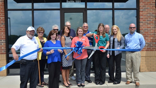 Staff members at AccelAbility Physical Therapy in Chelsea participate in a ribbon cutting ceremony on Sept. 2 to mark changes the office has undergone since opening several years ago. (Reporter Photo/Emily Sparacino)
