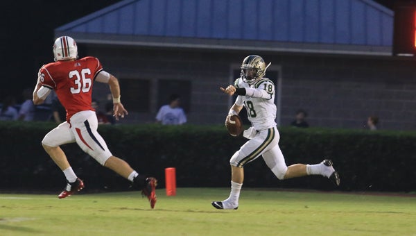 Griffin Rivers looks to pass downfield during Pelham's 54-20 loss at Homewood on Sept. 4. (For the Reporter / Dawn Harrison)