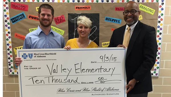 Blue Cross Blue Shield of Alabama representative Jeff Adams, right, presents a $10,000 grant to VES assistant principal Chase Holden and physical education instructor Ginger Aaron-Brush. (Contributed)