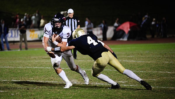 Oak Mountain quarterback Warren Shader gets by Briarwood's Sam Sherrod during the Eagles' 35-0 win over the Lions on Sept. 25. (Reporter Photo/Neal Wagner)