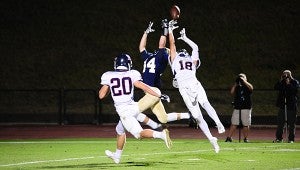 Briarwood's Carson Eddy fights for a pass as Oak Mountain's Thomas Pechman (18) and Hall Morton (20) attempt to intercept it. (Reporter Photo/Neal Wagner)