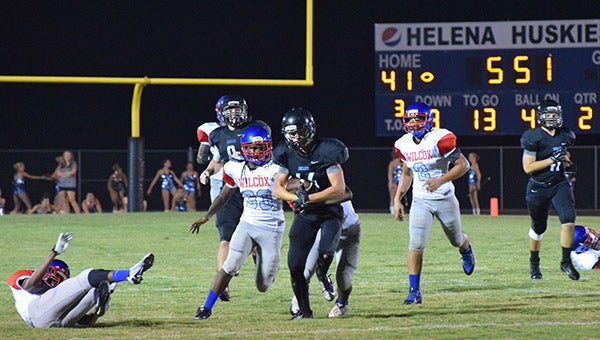 Helena running back Copeland Rosser (#44) slices through the Jaguars defense. Rosser finished the game with 121 yards rushing and two touchdowns. (For the Reporter/Brian Vansant)
