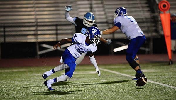 Tuscaloosa County's Jaden Thomas (18) attempts to recover a fumble as he is chased by Spain Park's Damon Wright (95) during the Jaguars' 24-0 victory over the Wildcats on Sept. 11. (Reporter Photo/Neal Wagner) 