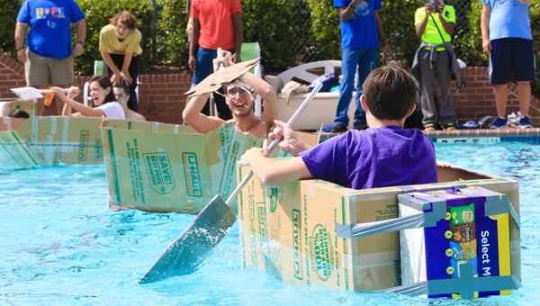 Jeff Johnson's Spain Park High School physics students paddle boats made from cardboard across the Greystone YMCA pool. (For the Reporter / Dawn Harrison)