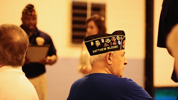 Members of American Legion Post 555 proudly display Matthew Blount's name on their caps. (Reporter Photo/Neal Wagner)