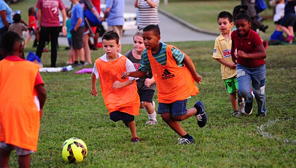 Meadow View Elementary School students join the Thompson High School girls' soccer team in a game during the "Have a ball with learning" event at MVES on Sept. 15. (Reporter Photo/Neal Wagner)