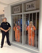 For reaching their goal of $15,000, HIS principal Kathy Paiml and assistant principal Genet Holcomb dressed up in prisoner clothes for the day and were locked up in “jail’ during lunch period. (Contributed)