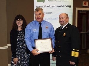 Paul Williams, center, was named Firefighter of the Year for the city of Chelsea. Williams is pictured with Chamber Chair Lisa McMahon and Fire Chief Wayne Shirley. (Reporter Photo/Neal Wagner)