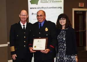 Donny Acton, center, was named Firefighter of the Year for the North Shelby Fire District. Acton is pictured with Chief Eugene "Buddy" Tyler and Chamber Chair Lisa McMahon. (Reporter Photo/Neal Wagner)