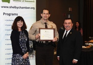 Chris Blevins, center, received the Officer of the Year award for the Shelby County Sheriff's Office. Pictured with Blevins are Chamber Chair Lisa McMahon and Shelby County Sheriff John Samaniego. (Reporter Photo/Neal Wagner)