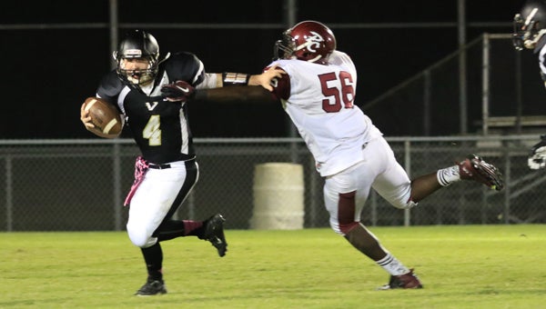 Matt Swift tries to avoid a Pickens county rusher during Vincent's Oct. 16 game. Vincent fell 70-0. (For the Reporter / Dawn Harrison)