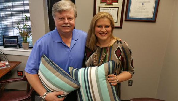 From left, Helena Mayor Mark Hall poses for a photo with Laura Joseph with the new cushions named after the city of Helena. (Contributed)