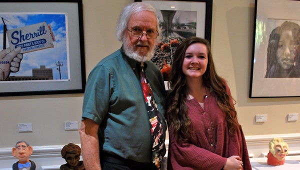 Dr. Lowell Vann and Hoover High School student Caitlin Gerard pose in front of Gerard's photograph at the Aldridge Gardens gallery on Oct. 8. (Reporter Photo / Molly Davidson)