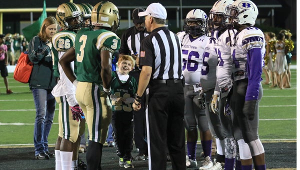 Gabe Griffin, 43, participated in the coin toss at Pelham High School before its game against Hueytown Oct. 2. Griffin was the team's honorary captain for the night. (For the reporter / Dawn Harrison)