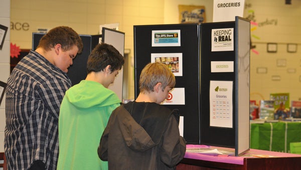 Students at Calera High School try to budget for groceries at the Keeping it Real program Oct. 23 hosted by the Greater Shelby Chamber of Commerce. (Contributed)