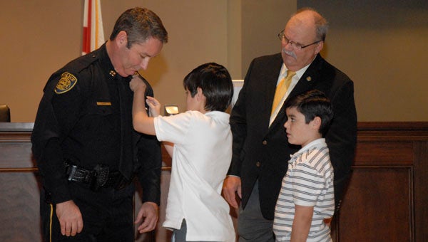 After being promoted to the rank of captian on the Pelham Police Department, Capt. Davy Lott's sons pinned on his new badge Oct. 8. (Reporter photo / Jessa Pease)