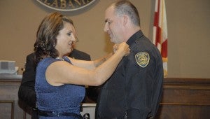 The Pelham Police Department promotes Lt. David Rushton to the rank of captian, and Rushton's wife pins on his new badge. (Reporter photo / Jessa Pease)