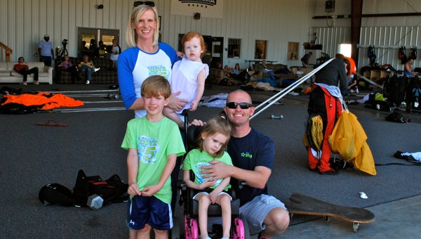The Chandler family, Amy, Courtney, Colton, Carly and Dustin, stand at Skydive Alabama before skydivers prepare to jump on Oct. 11. (Reporter Photo / Molly Davidson)