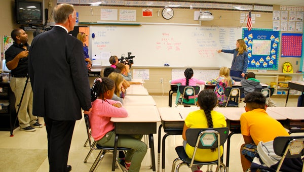 Gov. Robert Bentley looks on as Sarah Weaver's third grade class uses different strategies to solve a complicated addition equation. (Reporter Photo / Molly Davidson)