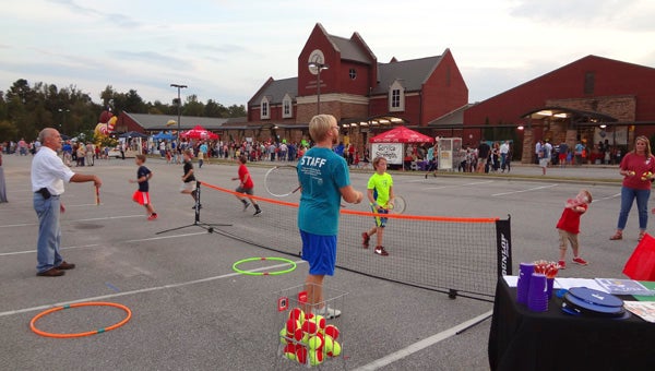 Children play tennis at the Greystone YMCA booth at the Chelsea Park Elementary School Fall Festival on Oct. 9. (Reporter Photo/Emily Sparacino)