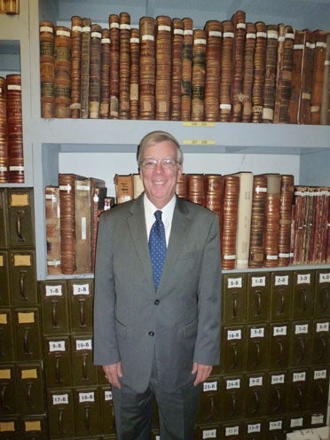 Dr. Fred Olive, newly installed president of the Shelby County Historical Society, stands in front of Shelby County historical and probate records at the Shelby County Museum and Archives. (Contributed)