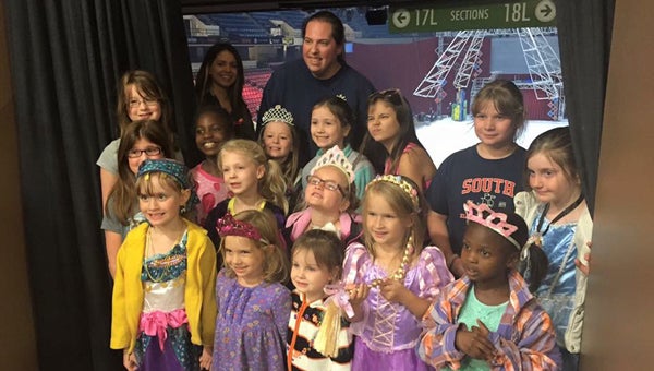 Girl Scout Troop No. 564 attended Disney on Ice with Scout Leader Jane McDaniel. Girls are ages kindergarten through fifth grade and attend Elvin Hill, Shelby and Forest Oaks Elementary schools. Front row: Anna Lee, Cassidee Moore, Kylee Elliot, Lorelei Young, Sarah Burrows, Dakota Feneck, Skyler Bailey; middle row: Amy Lee, Abigail Fuller, Abigail Moss; and back row: Peyton Morgan, Evie Horst and Annalee Fuller (little sisters), MacKenzie Hallmark and Camille Moore. (Contributed)