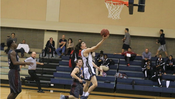 Luke Dyson drives to the basket during Briarwood's Nov. 19 win over Benjamin Russell. (For the Reporter / Dawn Harrison)