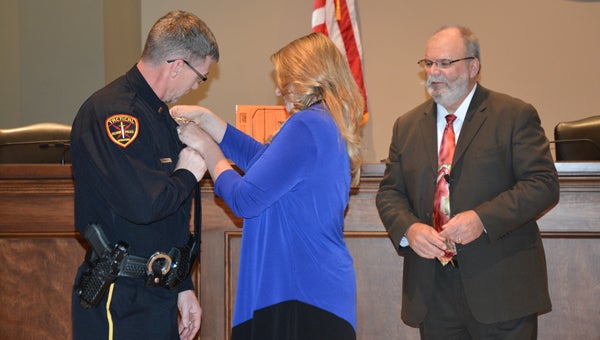 Lt. Mike Roberts’ wife pins on his new badge illustrating his new rank with the Pelham Police Department. (Reporter photo / Jessa Pease) 