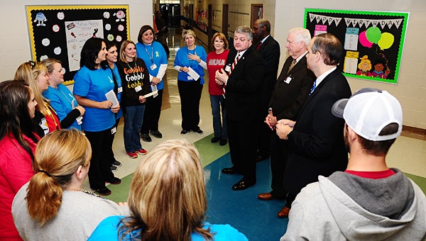 Alabaster School Superintendent Dr. Wayne Vickers, center, surprises Creek View Elementary teachers with extra compensation checks on Nov. 24. (Reporter Photo/Neal Wagner)