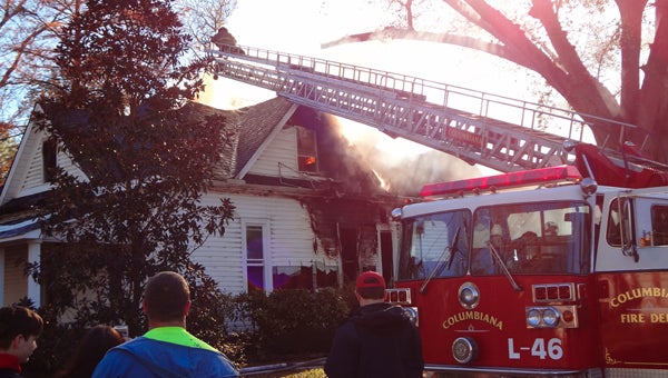 Columbiana firefighters work to extinguish a fire at the home of former Shelby County Schools Superintendent Evan Major and his wife, Linda, on the morning of Nov. 23. (Reporter Photo/Emily Sparacino)