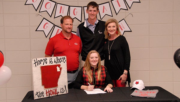 Grayson Gladden, center, signed her National Letter of Intent to play women’s golf at Arkansas State University on Nov. 12 at Helena High School. (Reporter Photo/Graham Brooks)