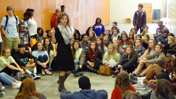 Chelsea High School Peer Helpers adviser Jennifer Bailey talks to students in a large-group session during a district-wide Peer Helper Summit on Nov. 10 at CHHS. (Reporter Photo/Emily Sparacino)
