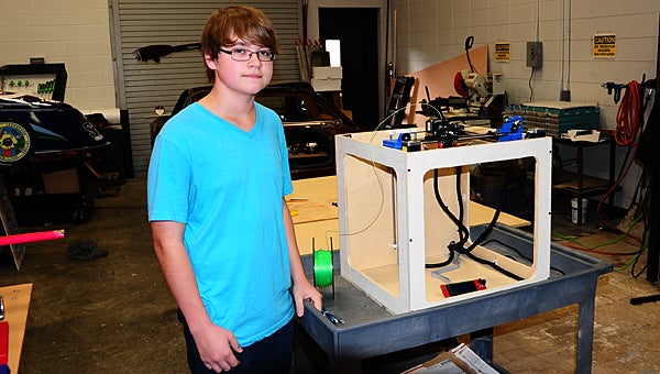 Thompson High School freshman Seth Folsom showcases the low-cost 3D printer he built as part of Brian Copes’ engineering class. (Reporter Photo/Neal Wagner)