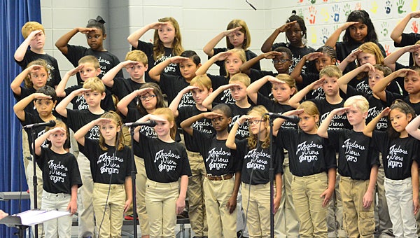Meadow View Elementary School third-graders in the Meadow View Singers choir salute veterans in attendance at the school’s Veterans Day program on Nov. 6. (Reporter Photo/Neal Wagner)