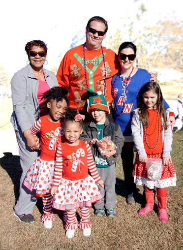New acquaintances at the parade pictured here are Kenley and Kelsey Marshall with Colette Rare, and Derek and Sonia Blumstein with Madeleine and Judah Kai in his elf hat. (Contributed)