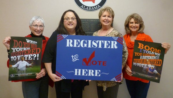 The Board of Registrars want you to register to vote at the Frank C. "Butch" Ellis Building in Columbiana and receive your choice of a free coach Nick Saban or coach Gus Malzahn poster, as long as supplies last. Pictured are Registrars Emily Gravitt holding Saban's poster, Heidee Vansant (chief clerk) and Lois Cooper holding the "Register to Vote Here" sign, and Carol Hill holding Malzahn's poster. (Contributed)