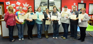 Parent graduates of the FEA from Vincent Elementary School display their certificates at their final session Dec. 15. (Reporter Photo/Emily Sparacino)