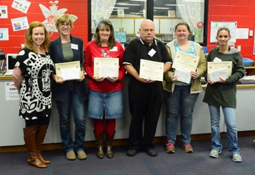 Parent graduates of the FEA from Wilsonville Elementary School hold their certificates at their final session Dec. 15. (Reporter Photo/Emily Sparacino)