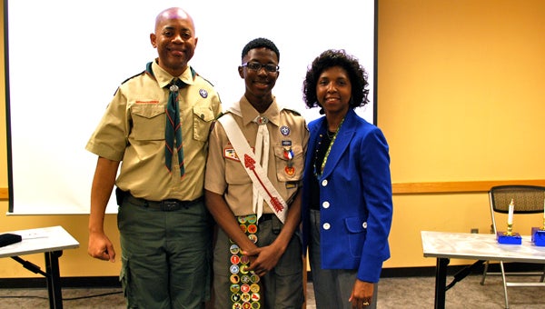 Chris Tanner with his parents, Ron and Cathy Tanner, pose for a picture following after the Eagle Scout Court of Honor ceremony on Dec. 6. (Reporter Photo / Molly Davidson)