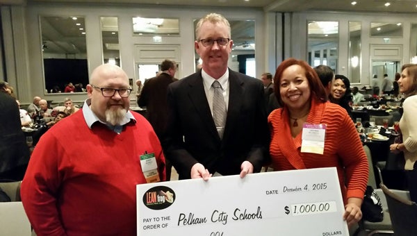 Pelham Superintendent Dr. Scott Coefield accepts a $1,000 award from Lean Frog Solutions after PCS is named one of Alabama’s Best K-12 Practices. (Contributed) 