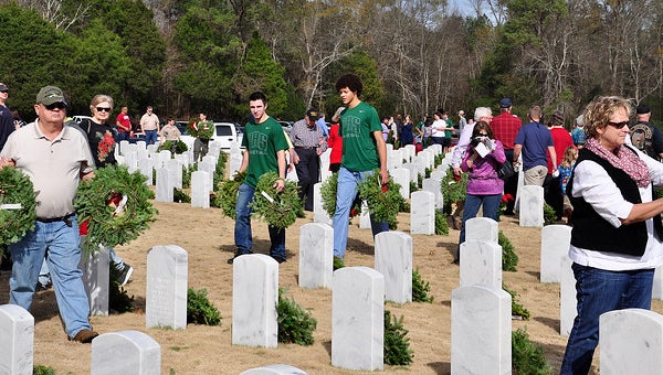 More than 100 athletes, coaches and parents from Riverchase Middle School and Pelham High School participate in Wreaths Across America at the Alabama National Cemetery. (Contributed)