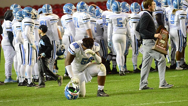 Spain Park defensive lineman Brett Cocke (58) kneels before his team receives the AHSAA Class 7A runner-up trophy after the Jaguars fell 14-12 to the McGill-Toolen Yellow Jackets. (Reporter Photo/Neal Wagner)