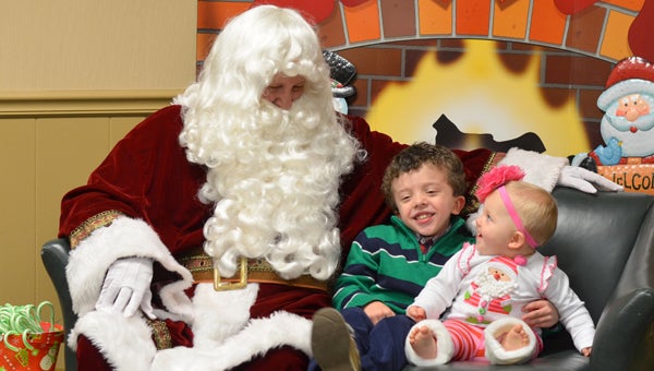 Zion and Adah Futral laugh with Santa Claus at the Pelham Public Library’s annual brunch with Santa Dec. 16. (Reporter photo / Emily Klein) 