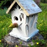 Graham creates decorative birdhouses, such as "Alice in the White Forest," 2015.