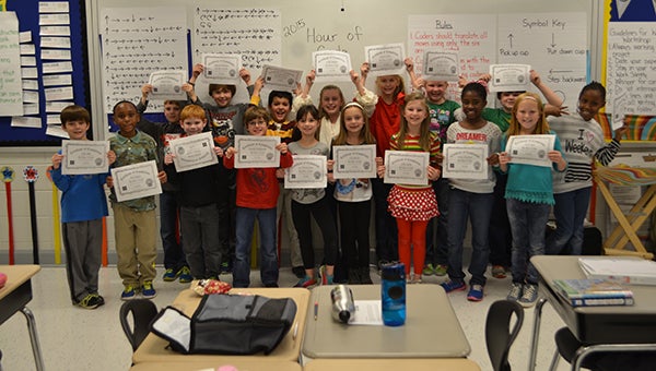 Third grade students in Carissa Blackerby’s class show off their certificates after completing an “Hour of Code” activity on Wednesday, Dec. 9. (Reporter Photo/Graham Brooks)