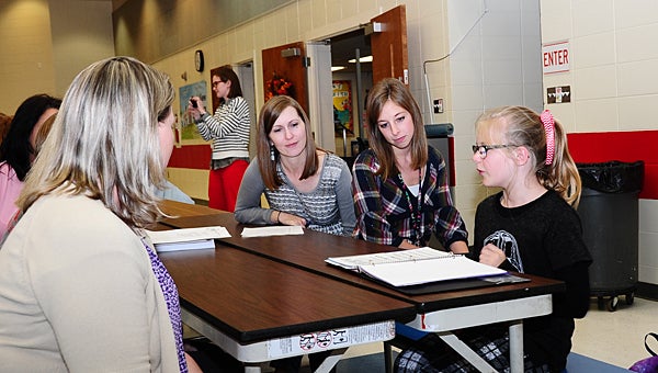Creek View Elementary School student Gracie Parker, right, leads a presentation to parents and teachers during a Dec. 7 faculty meeting. (Reporter Photo/Neal Wagner)