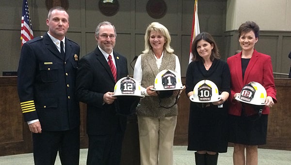 From left, Alabaster Fire Chief Jim Golden presents fire helmets to Councilman Rick Walters, Mayor Marty Handlon, Building Safety Coordinator Sherri Proctor and Councilwoman Stacy Rakestraw. (Reporter Photo/Neal Wagner)